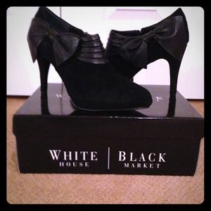 Black suede booties with leather detail and bow