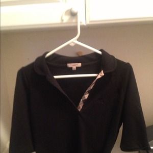 Woman's black burberry polo shirt and teal