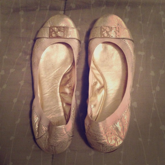 Gold metallic Coach flats.