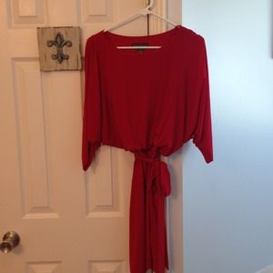 A beautiful red dress with tie waist belt.