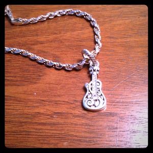 Silver guitar bracelet.