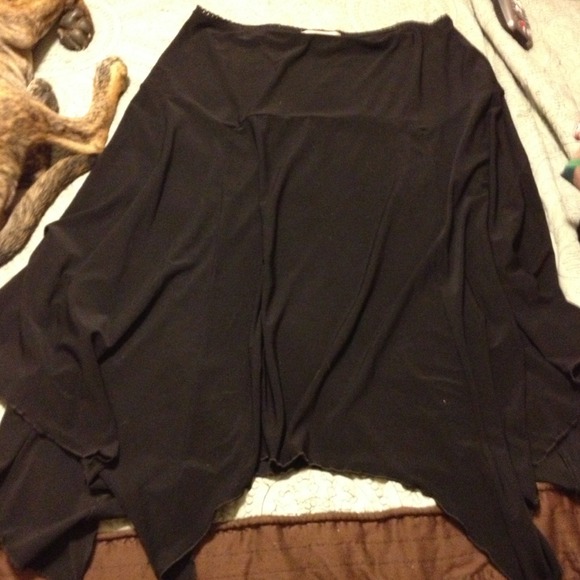 Stretchy black skirt with asymmetrical hemline.