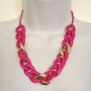 Chunky hot pink and gold necklace.