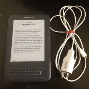 A black kindle with charger.