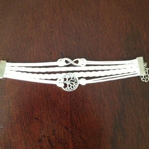 Leather banded bracelet with charms. brand new