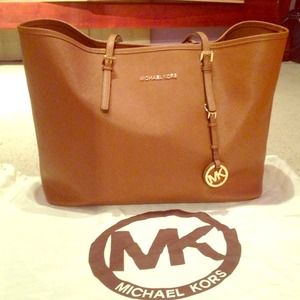 ONHOLD Used Michael Kors Tote Luggage color/brown.