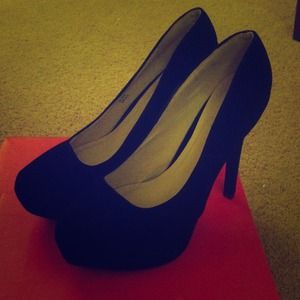 Black velvet heels .