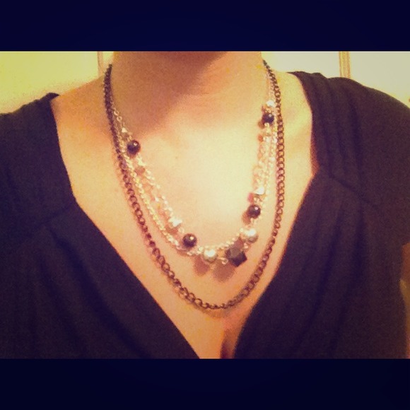 Black and silver colored multi strand necklace.