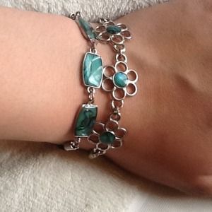 2 bracelets with a blue stone in the middle