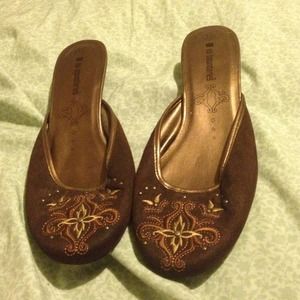 Open back slipper with a slight heel