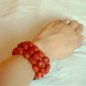 Triple strand red bead stretch bracelet