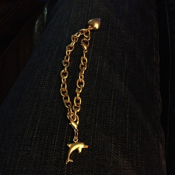 Gold charm bracelet with dolphin