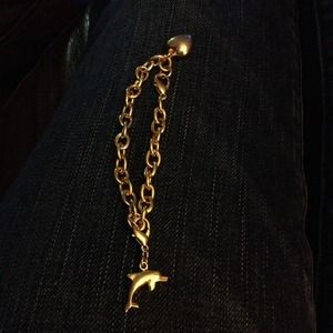 Gold charm bracelet with dolphin