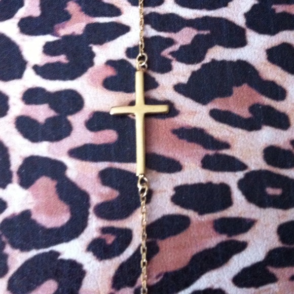 Gold cross necklace.