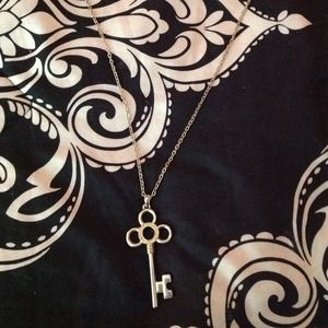 Long gold necklace with old fashioned skeleton key
