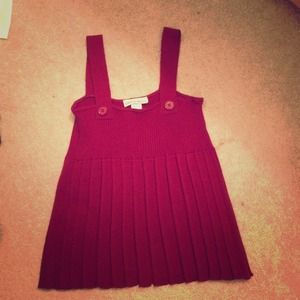 Deep red sleeveless top.