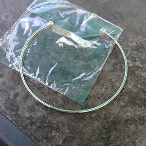 New in package silver tone necklace.