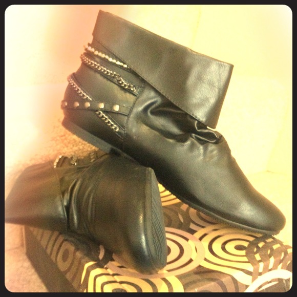 Flat ankle boots with chain embellishment.