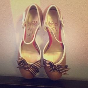 Brown and white heeled Mary Janes with bows