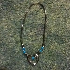 A metal necklace with blue gems
