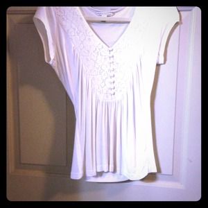 White top, buttons down chest