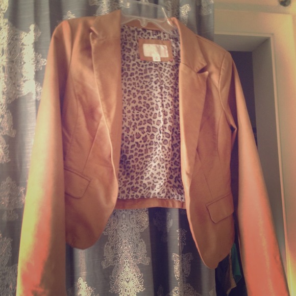 Light tan leather jacket.  Firm fitted.