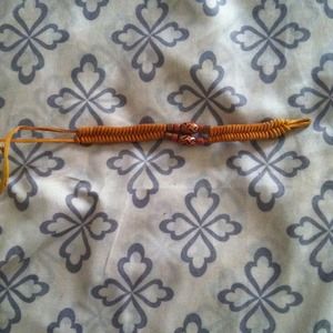Orange woven bracelet with bead accents
