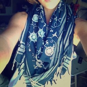 A navy blue scarf with fringe detailing