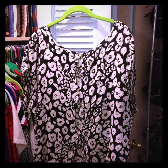 Super cute cow print top with button down back.