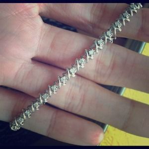 White gold and diamond xo-style tennis bracelet.