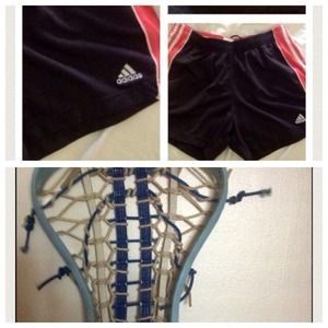 Woman lacrosse stick and Adidas shorts