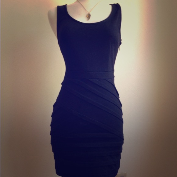 Simple black dress with bandage style detailing.
