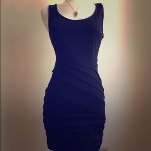 Simple black dress with bandage style detailing.