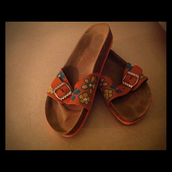 Orange sandals with buckle on the side