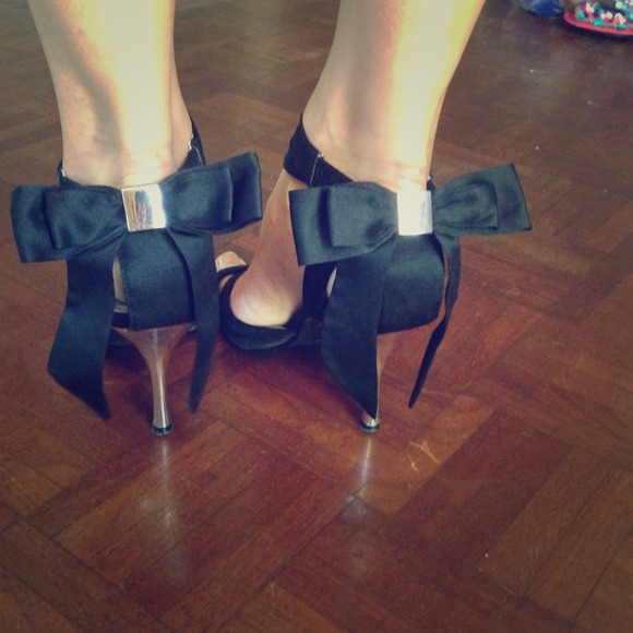 Black strappy heels with bows on the back