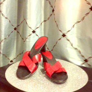 Red PREDICTIONS sandal with a heel.