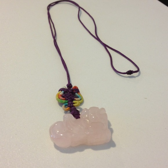 Asian necklace. Pink lion stone. On purple strap.