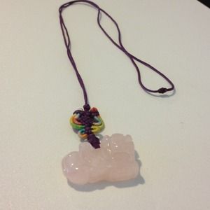 Asian necklace. Pink lion stone. On purple strap.