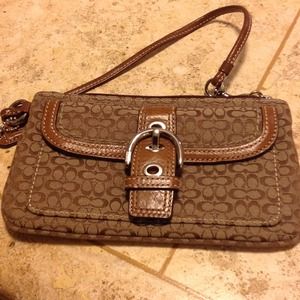 Genuine Coach signature wristlet .