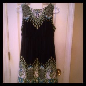 Sleeveless black dress with green floral detail