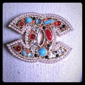 CHANEL logo brooch pin. Gold plated and jeweled.