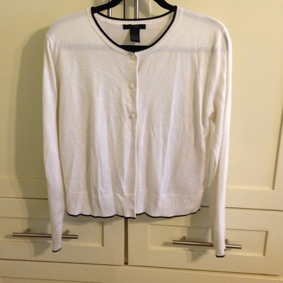 White cardigan  with black lined edges.