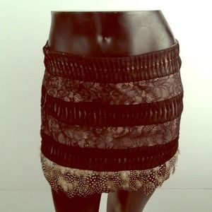 Bebe black and nude lace skirt w/feather hem, new.