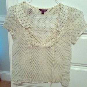 A sheer black and white polka dot top