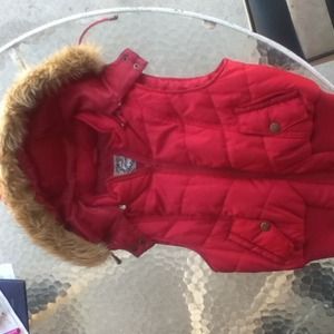 Red vest with faux fur trim on the hood