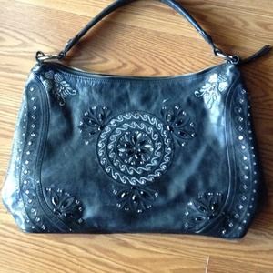 Leather purse and black pumps