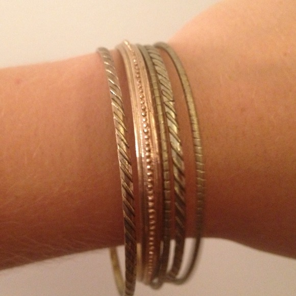 Multiple gold (colored) bangles