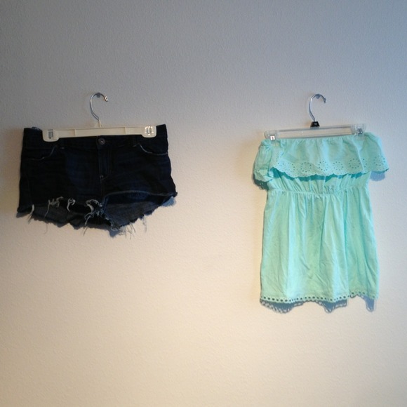 Dark blue shorts with a strap less light blue top
