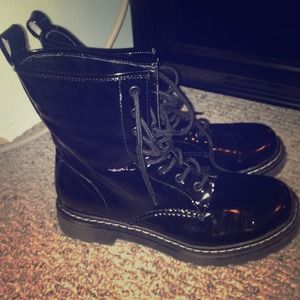 Black faux patent leather combat boots.