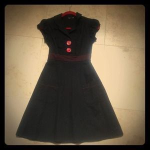 Black dress with red buttons and  thread accents